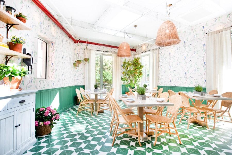 The Greenhouse, a private dining room with a green tile floor, as it would be set up for service.