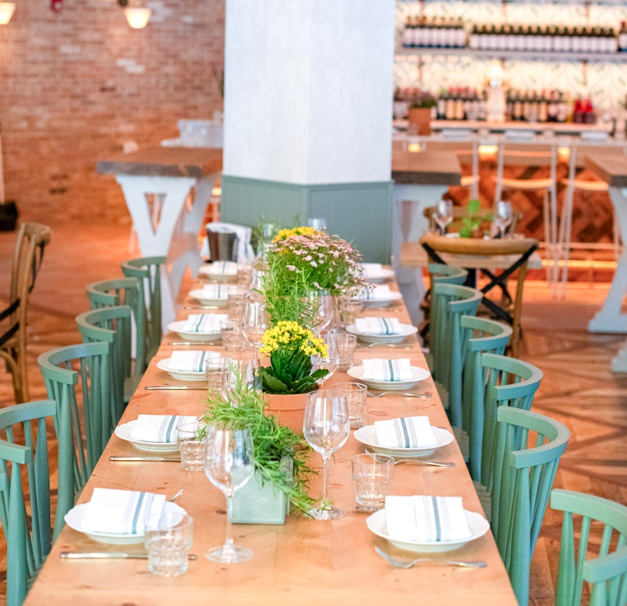 The communal dining table at Rosemary's Midtown, in the center of the dining room.