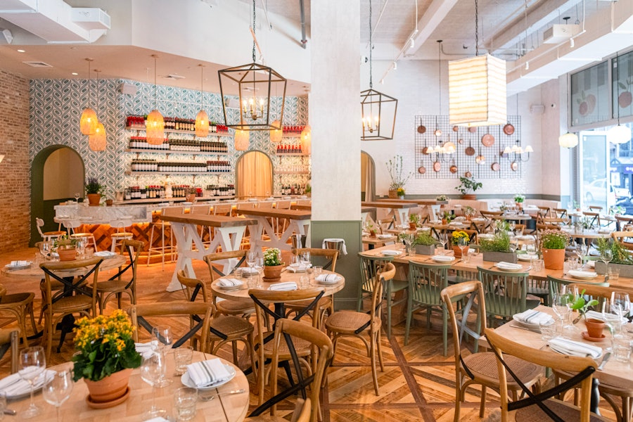 A wide shot of the dining room at Rosemary's Midtown as set up for service.